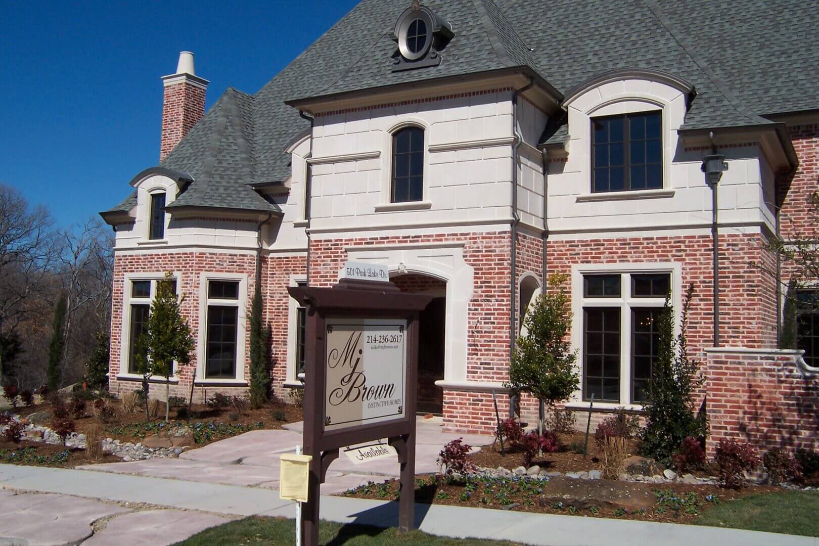 Elegant brick house with real estate sign