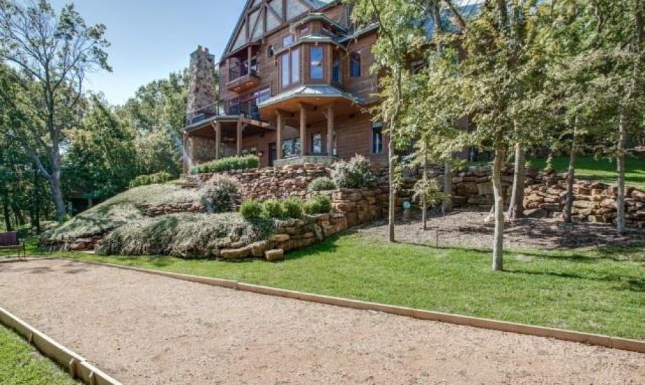 A home with a bocce court in front of it.