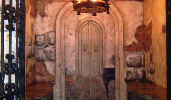 A doorway in a room with a fireplace.