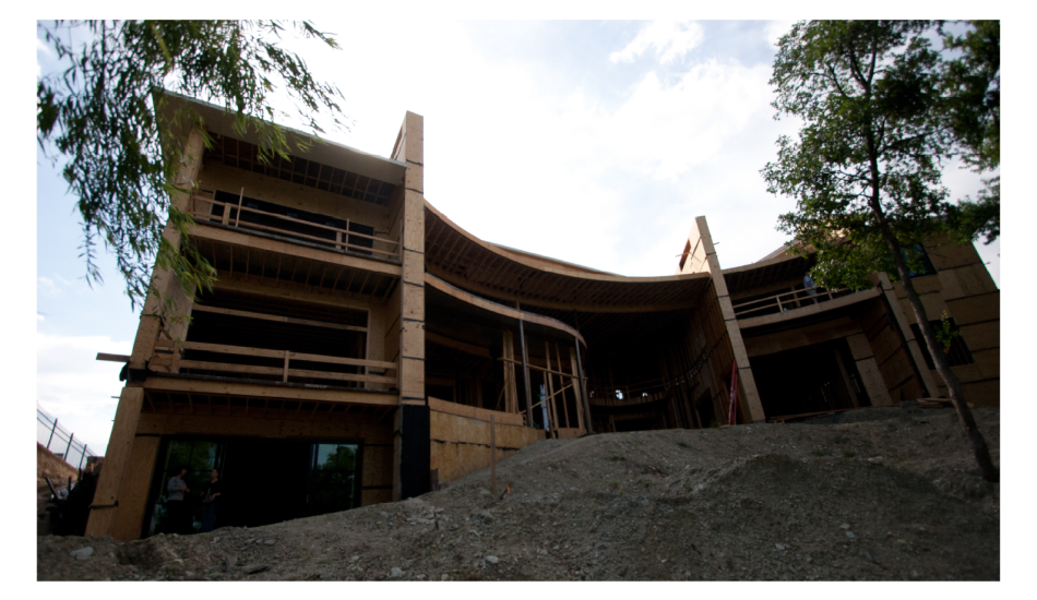 A house under construction with a wooden roof.