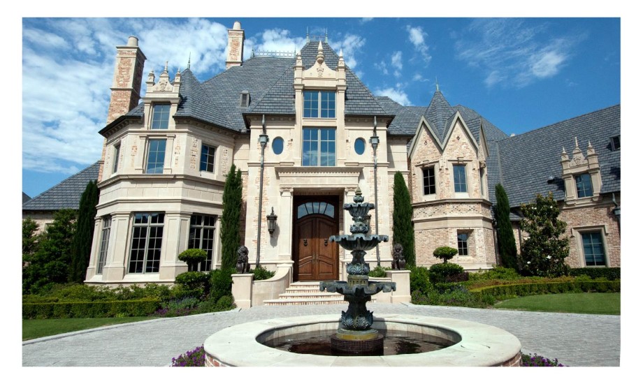 Grand stone mansion with ornate front fountain