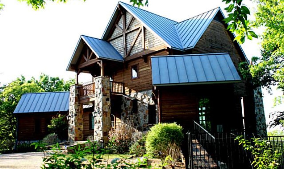 Rustic stone and wood cabin with metal roof