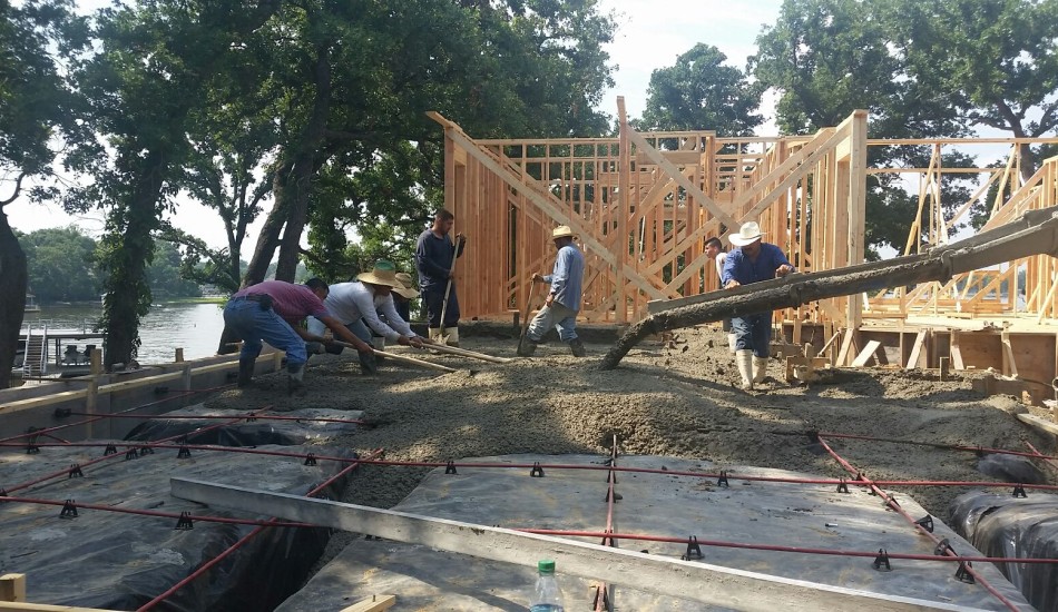 A group of construction workers working on a house.