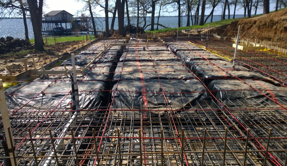 A concrete slab on the ground near a body of water.