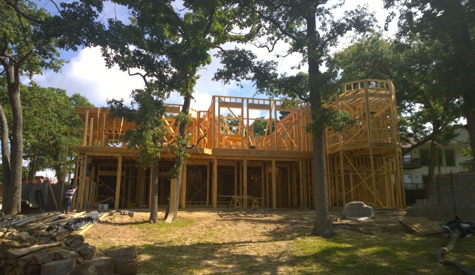 Two-story wooden house framing under construction