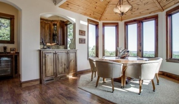 Cozy dining nook with wooden ceiling, bay windows