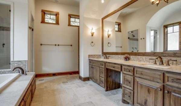 A bathroom with two sinks and a large mirror.
