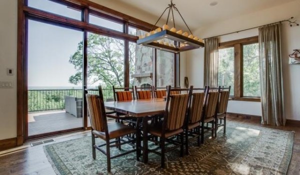 Sunlit dining room with long wooden table